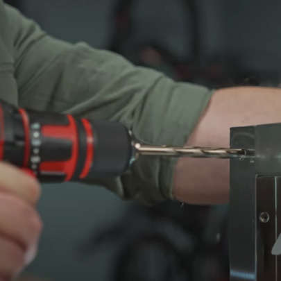 A man drills a hole with a cordless screwdriver