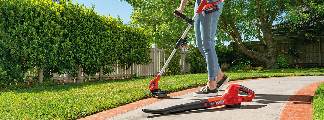 Working with a leaf blower and a scythe